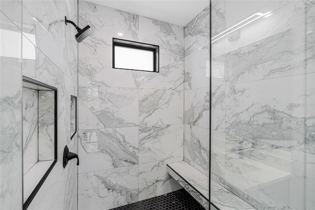 full bathroom with a marble finish shower