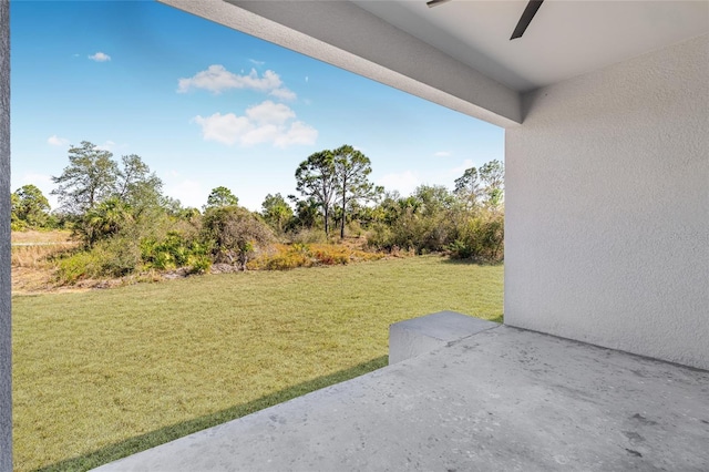 view of yard with a patio area and a ceiling fan