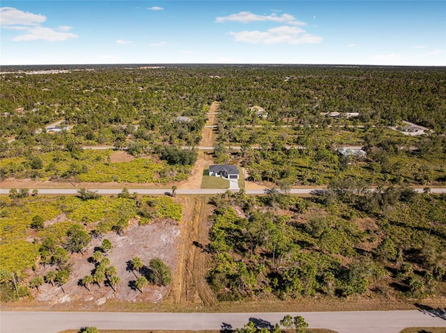 drone / aerial view featuring a wooded view