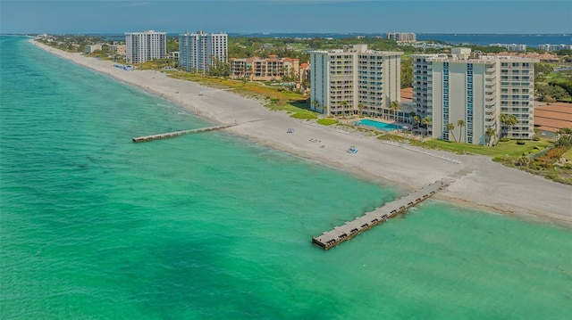 birds eye view of property with a water view, a view of the beach, and a city view