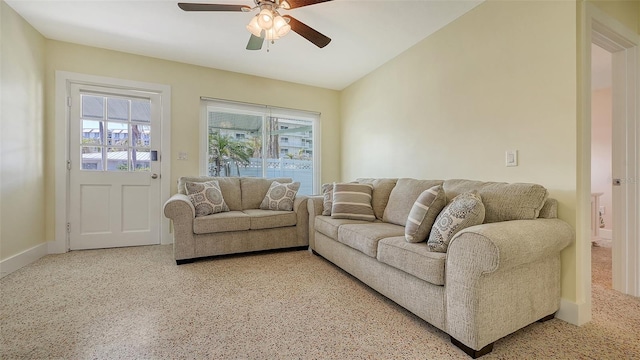 living room featuring lofted ceiling and a ceiling fan