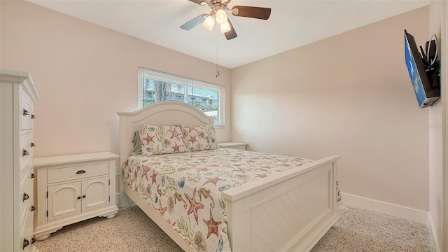 bedroom featuring light speckled floor, ceiling fan, and baseboards