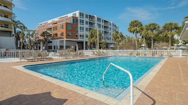 pool featuring fence and a patio
