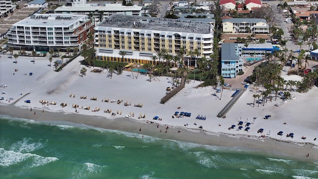 drone / aerial view featuring a view of city, a water view, and a view of the beach