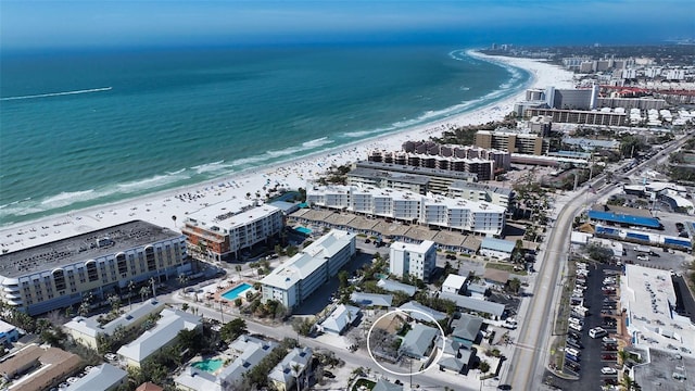 birds eye view of property featuring a view of city, a water view, and a beach view