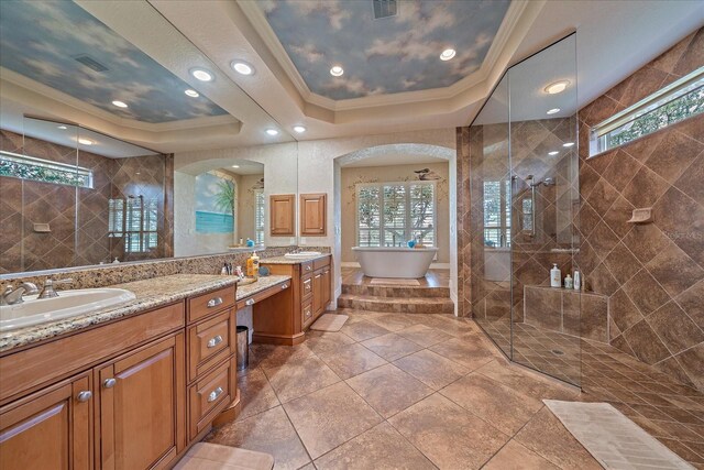 full bathroom featuring crown molding, a freestanding tub, a sink, and a walk in shower