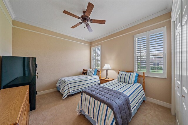 bedroom featuring light carpet, crown molding, and multiple windows