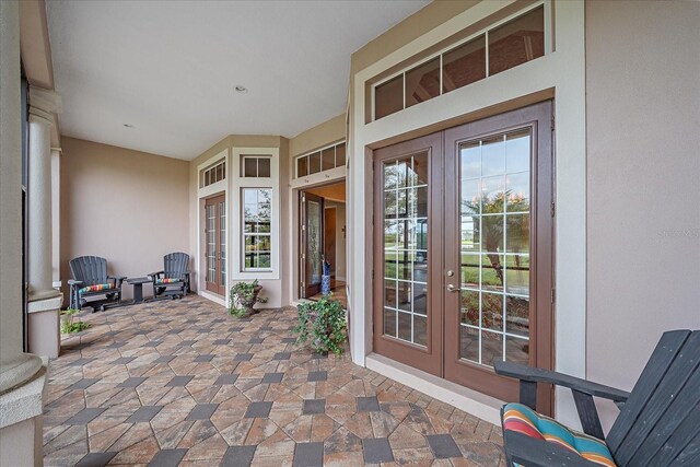 property entrance featuring french doors and stucco siding