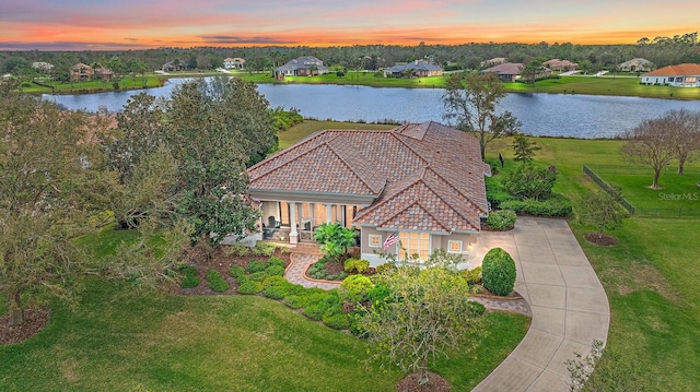 aerial view at dusk with a water view