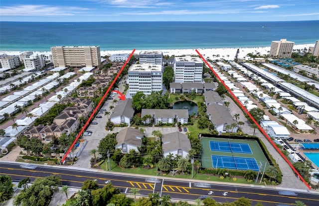 bird's eye view with a water view and a beach view