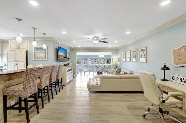 living area with light wood finished floors, ornamental molding, and recessed lighting