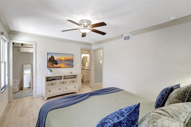 bedroom with baseboards, light wood-style flooring, visible vents, and crown molding