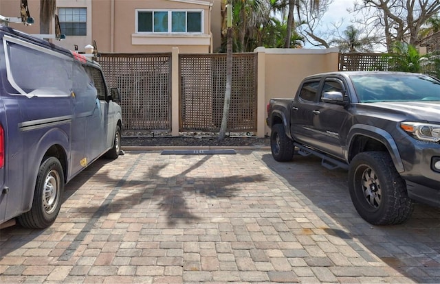uncovered parking lot featuring fence