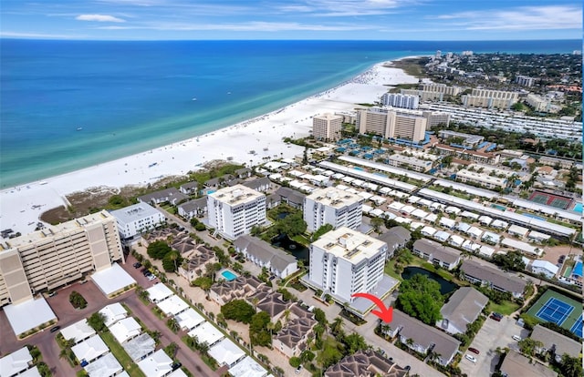 birds eye view of property featuring a water view, a view of the beach, and a city view