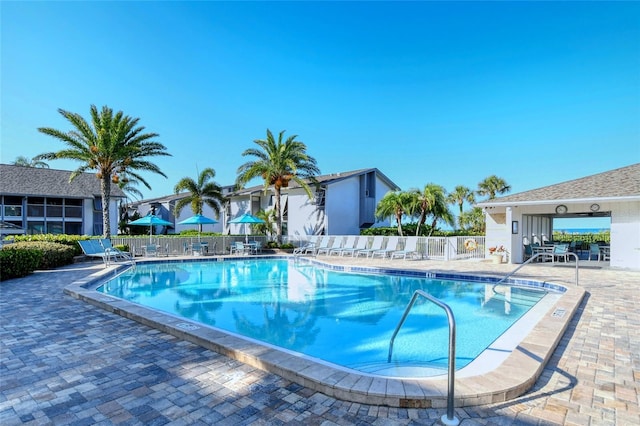 community pool featuring a patio area and fence