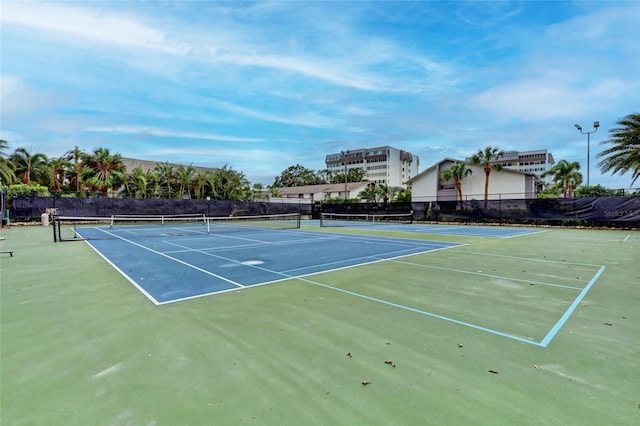 view of sport court featuring fence