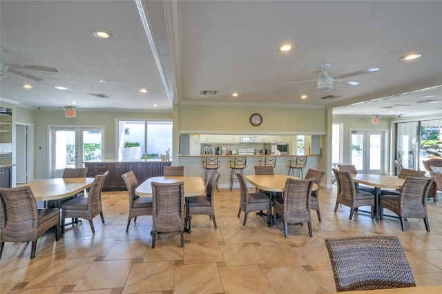 dining space with plenty of natural light, ceiling fan, and french doors
