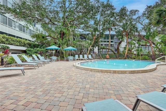 pool featuring a patio and fence