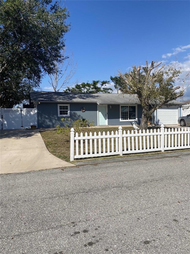 ranch-style house featuring a fenced front yard