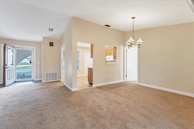 interior space featuring a textured ceiling, a notable chandelier, light carpet, visible vents, and baseboards