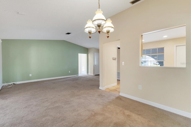 empty room featuring lofted ceiling, visible vents, an inviting chandelier, light carpet, and baseboards