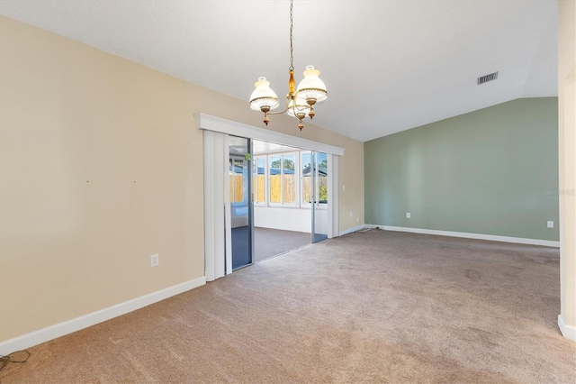 empty room featuring carpet, a notable chandelier, visible vents, vaulted ceiling, and baseboards