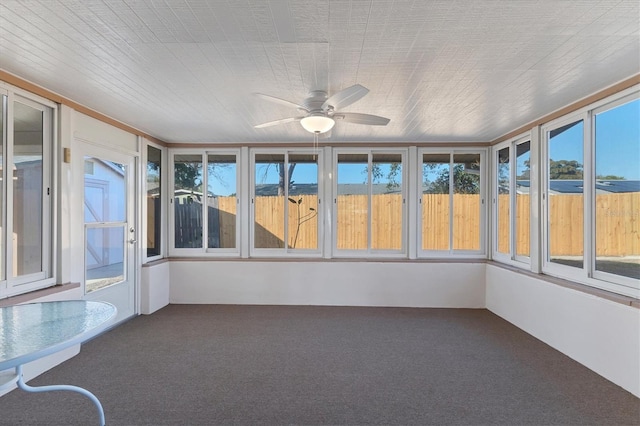 unfurnished sunroom with a ceiling fan