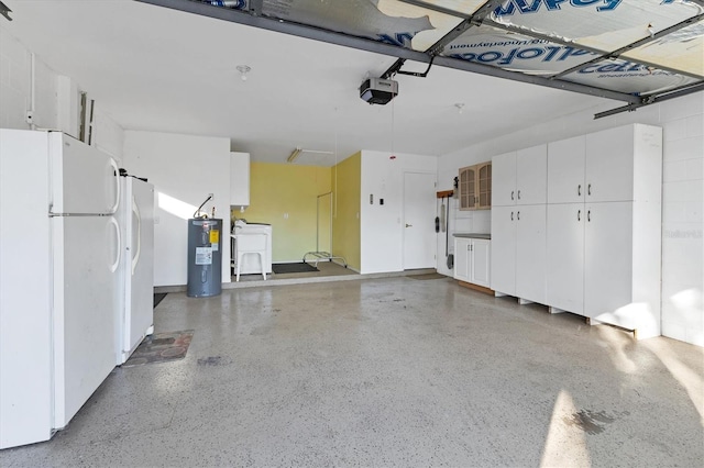 garage with electric water heater, a garage door opener, a sink, and freestanding refrigerator