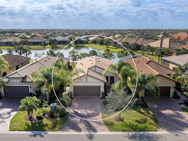 drone / aerial view featuring a water view and a residential view