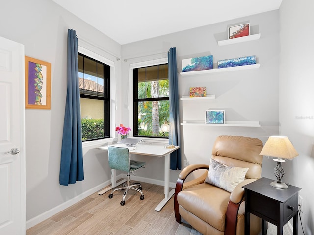 office area featuring light wood-style flooring and baseboards