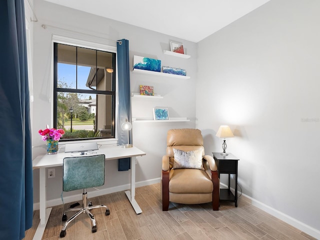 office space featuring light wood-style flooring and baseboards