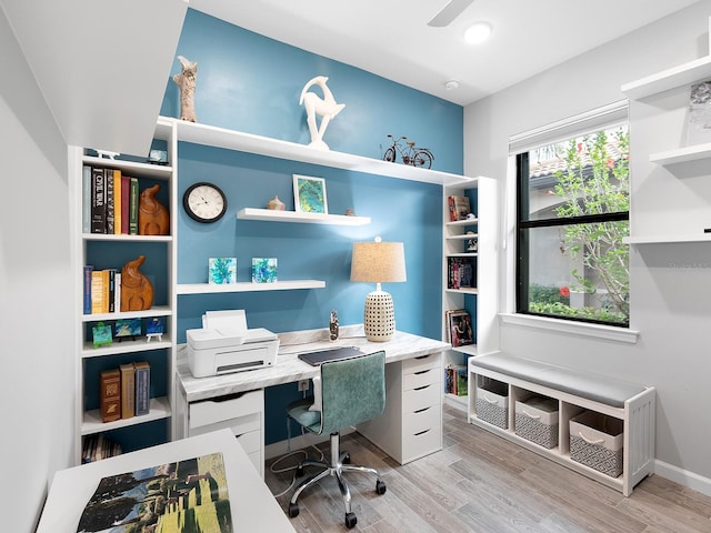 office space with light wood-style flooring, baseboards, and a ceiling fan