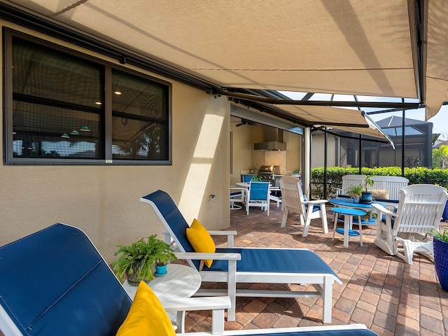 view of patio featuring outdoor dining area and a lanai