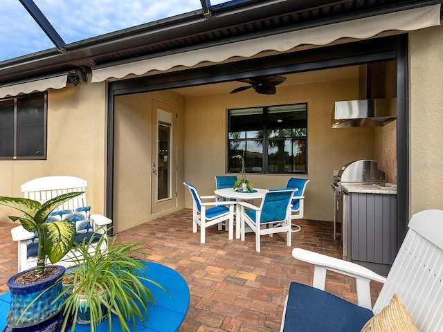 view of patio / terrace featuring a ceiling fan, outdoor dining area, and exterior kitchen