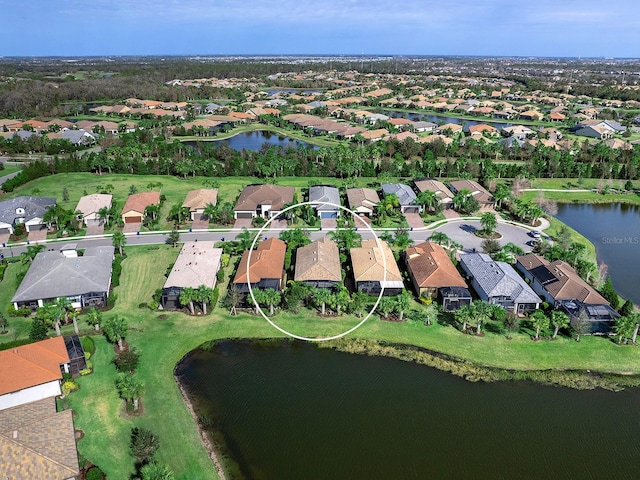 drone / aerial view with a water view and a residential view