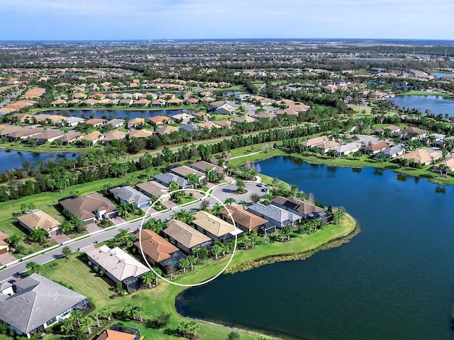 birds eye view of property featuring a residential view and a water view