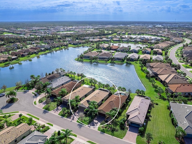 birds eye view of property with a water view and a residential view