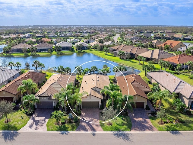 birds eye view of property with a water view and a residential view