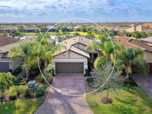 bird's eye view featuring a water view and a residential view