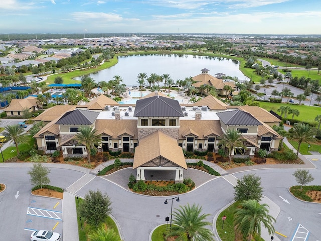 drone / aerial view featuring a residential view and a water view