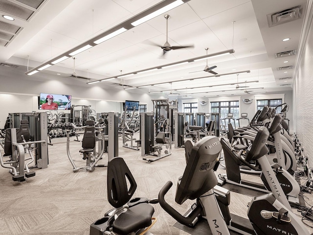 workout area featuring light carpet, ceiling fan, and visible vents