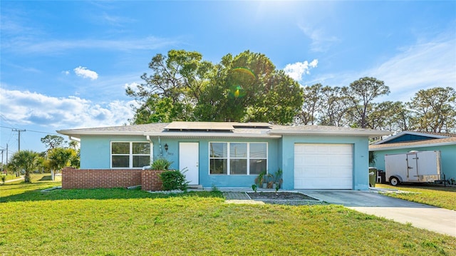 ranch-style house with stucco siding, concrete driveway, a front yard, roof mounted solar panels, and a garage