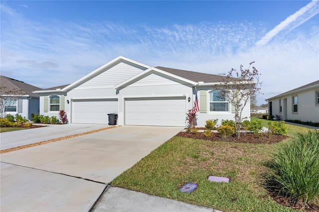 single story home featuring a garage, driveway, a front yard, and stucco siding