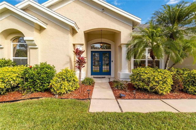 entrance to property with french doors and stucco siding