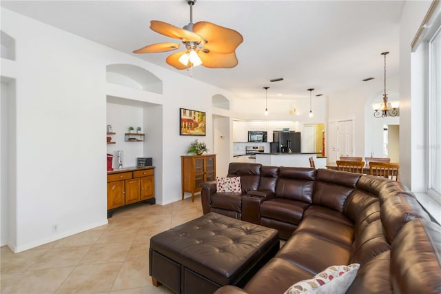 living room with light tile patterned floors, a ceiling fan, and baseboards