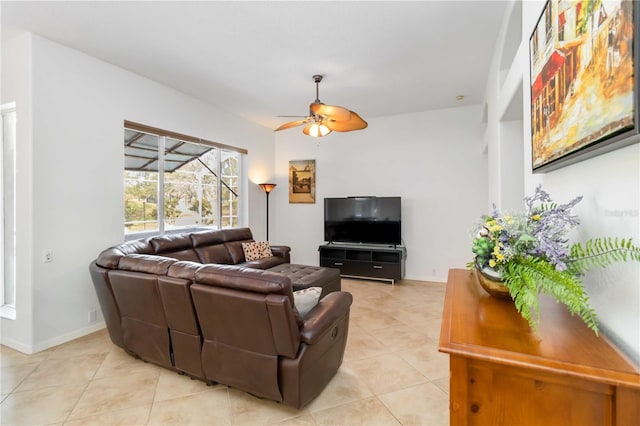living room featuring a ceiling fan, light tile patterned flooring, and baseboards