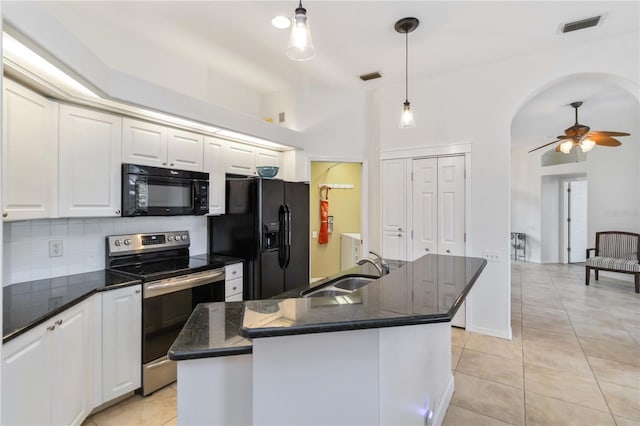 kitchen with black appliances, a sink, ceiling fan, and light tile patterned flooring
