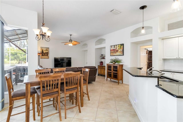 dining area with a ceiling fan and light tile patterned floors