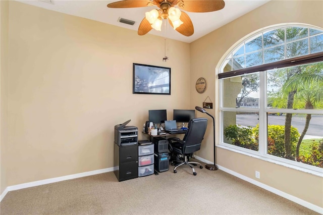 carpeted home office with a ceiling fan and baseboards