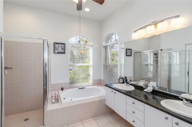 bathroom with a shower stall, ceiling fan, a bath, tile patterned flooring, and double vanity